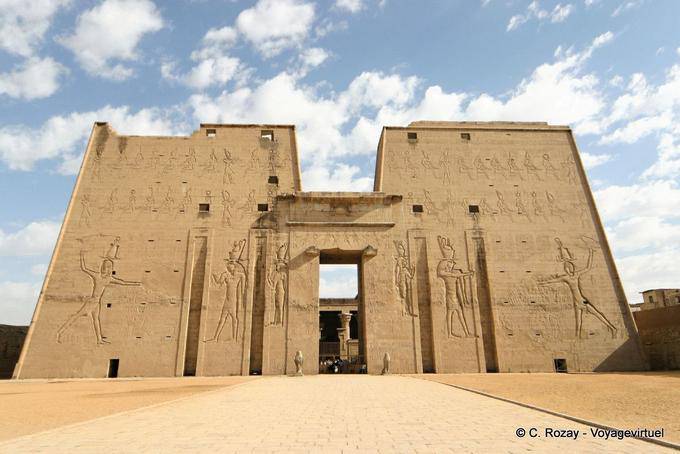 Edfu, la imponente fachada de la torre custodiada por dos estatuas de Horus en la entrada - Egipto