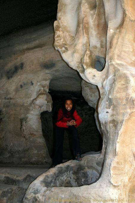Niño sonriente en un comedor cueva, equipado con una piscina, Little Petra - Jordania