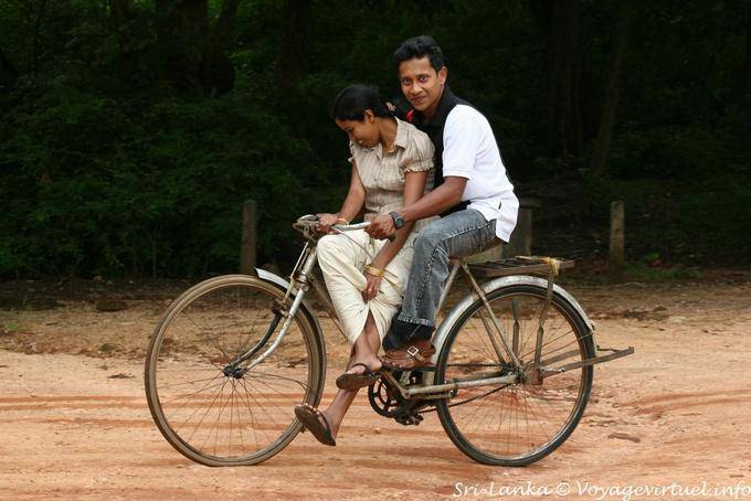Pareja de jóvenes en bicicleta de Sri Lanka en el sitio de Polonnaruwa - Ceilan Sri Lanka