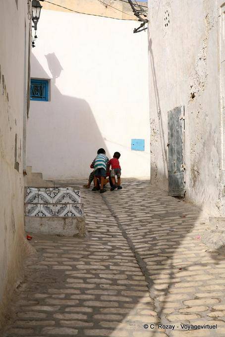 Los niños juegan en los adoquines medievales, Sousse medina - Túnez